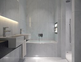 Un baño moderno con una bañera grande, dos lavamanos y una ducha.