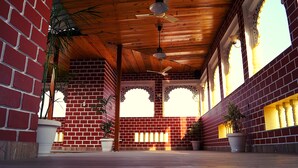 A covered area with red brick walls, wooden ceiling, and ceiling fans. - Spring Sky Udaipur by ShriGo Hotels (Udaipur)