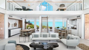 Un intérieur spacieux et moderne comprenant un coin repas, une cuisine et un espace détente.