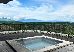 A hot tub with a view of mountains.