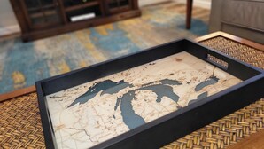 A framed map on a woven table. - Secluded 4BR Cottage Near Lake Michigan—Decks, Fire Pit & Pet‑Friendly (South Haven)
