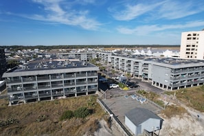 A multi-story parking garage with several levels of parking, surrounded by buildings and a clear sky. - Sea Cabin 233 - 2 Bed/2 Bath Condo with Ocean View  (North Myrtle Beach)