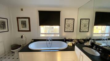 Combined shower/bathtub, towels, toilet paper