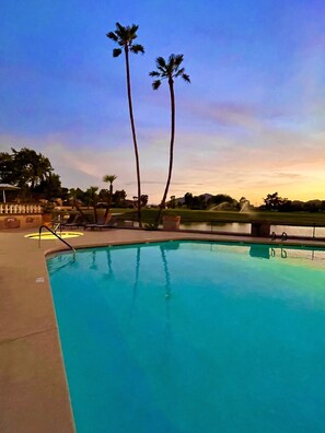 A swimming pool with a clear blue water surface, surrounded by a concrete deck and palm trees. - Luxurious Property with Dual Master Suites in McCormick Ranch (Scottsdale)