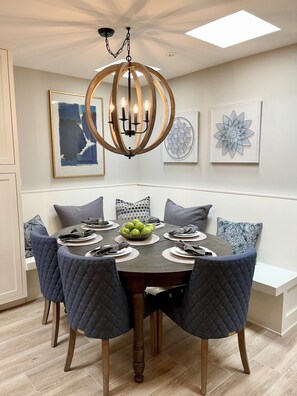 A dining room with a round table, six chairs, and a chandelier. - Luxurious Property with Dual Master Suites in McCormick Ranch (Scottsdale)