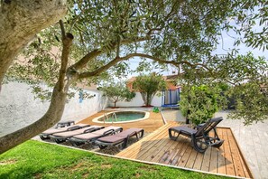 A backyard with a wooden deck, lounge chairs, a small pool, and a tree. - Holiday House Ulika with Private Pool (Loborika)