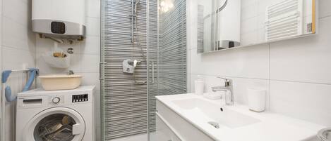 Shower, hair dryer, towels, toilet paper