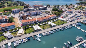 An aerial view of a marina with boats docked, surrounded by buildings and a clear view of the sea. - 150 m from the Beach, Medulin Center - Belvi C2 (Medulin)