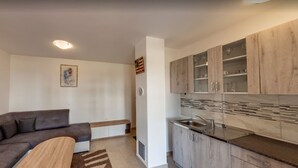 A modern kitchen with wooden cabinets and a built-in sink. - 150 m from the Beach, Medulin Center - Belvi C2 (Medulin)