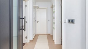 A hallway with white walls, a beige floor, and a door at the end. - Villa Gigetto with Private Pool and Big Garden (Medulin)