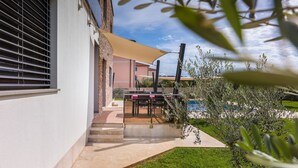 A patio area with a pool, outdoor furniture, and a pergola. - Villa Gigetto with Private Pool and Big Garden (Medulin)