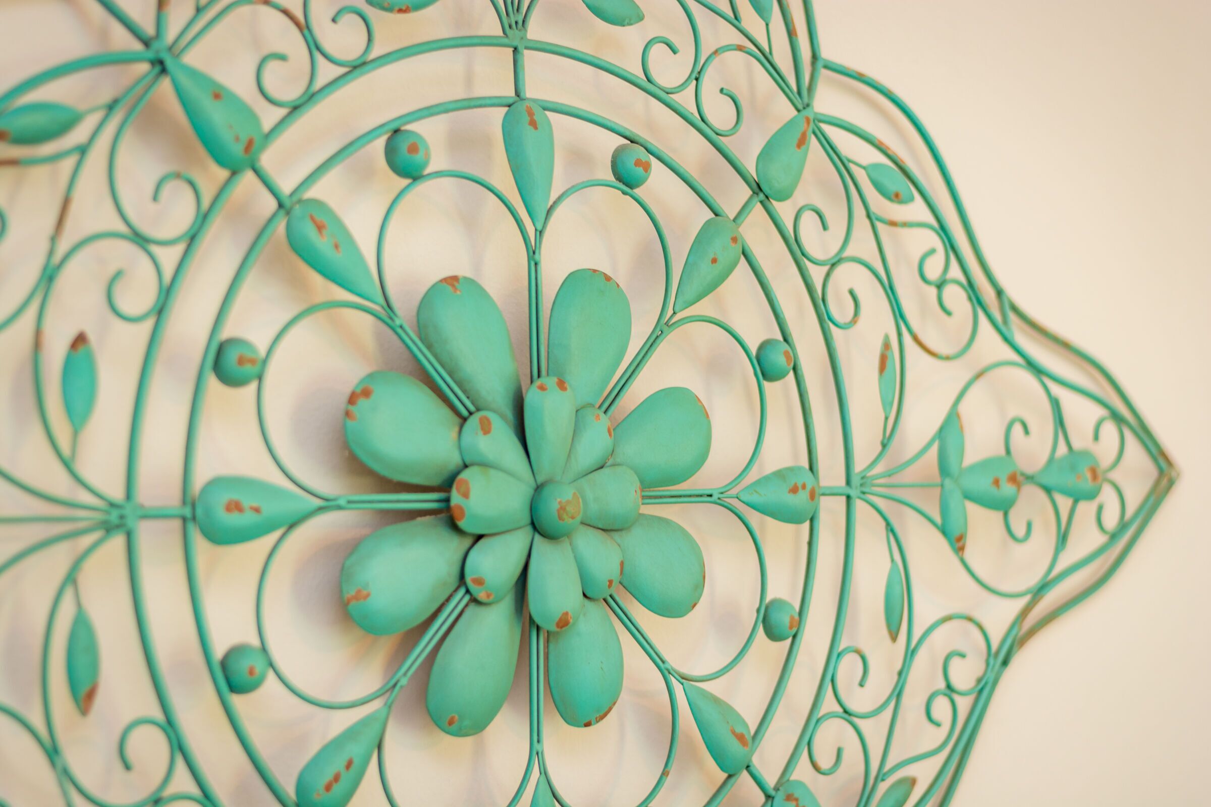 A decorative metal wall art with a floral design.