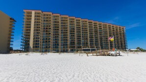 A large hotel with multiple floors and balconies, situated on a sandy beach. - Phoenix V Unit 816 (Orange Beach)
