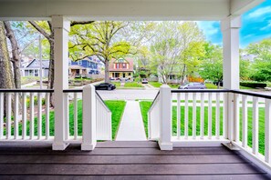 A porch with a view of a residential street.