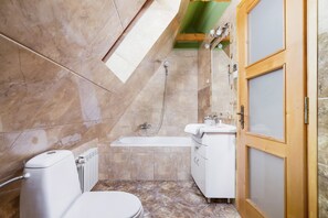 Bathtub, hair dryer, towels, shampoo