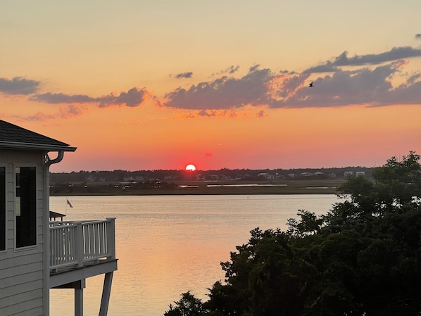 A sunset over a body of water with a house and trees in the foreground. - Welcome to your Sea Escape 2 Ocean and Sound Views Pet Friendly (Topsail)