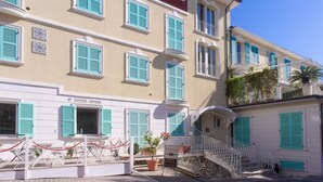A multi-story building with balconies, a staircase, and a sign indicating a restaurant. - N236 Numana, two-room apartment with sea view in the heart of the town (Numana)