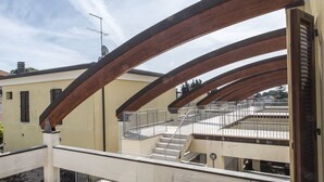 A multi-level building with a balcony, metal railings, and a staircase. - N036 - Numana, two-room apartment with terrace in residence with swimming pool (Maratta)
