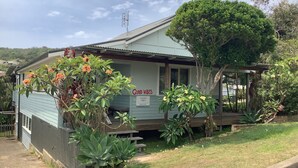 A single-story house with a porch, a 'Good Vibes' sign, and a mailbox. - Good Vibes, 18 East Street (Crescent Head)