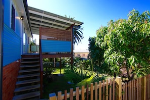 Enjoy a balcony with seating area overlooking lush greenery and a tropical garden.