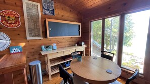 Relax in this inviting room with a round table and two chairs, a large window offering a view of the outdoors.