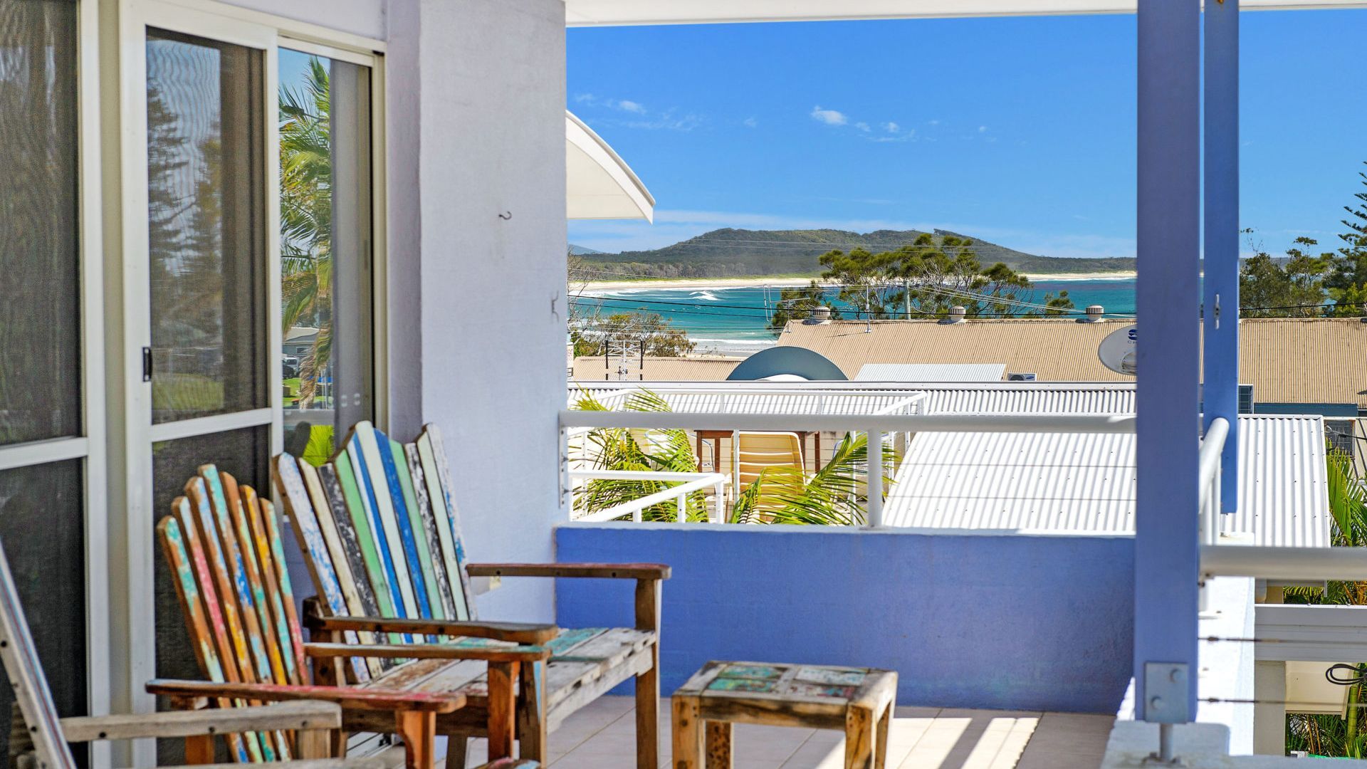 Een balkon met uitzicht op een strand en de oceaan.
