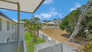 A residential area with houses, a paved driveway, and a fenced yard.