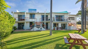 A two-story building with a balcony and a covered patio area. - Beachfront 1, 25 Willow Street (Crescent Head)
