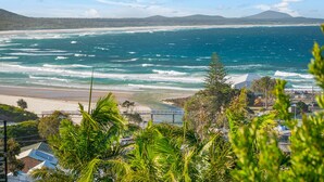 A coastal view with a beach, ocean waves, and a bridge. - Beau Soleil, 28 East Street (Crescent Head)