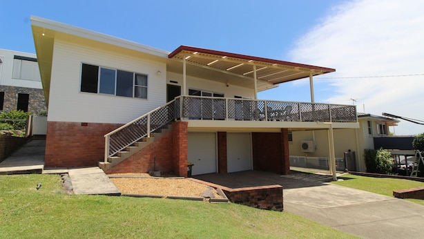 A two-story house with a covered patio, a staircase, and a garage. - Horizons 7 East Street, Crescent Head (Crescent Head)
