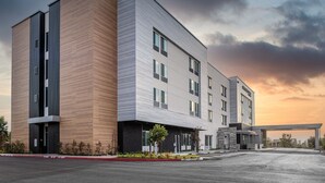 A modern hotel with a two-story structure, large windows, and a covered entrance. - SpringHill Suites by Marriott Riverside Redlands (Redlands)