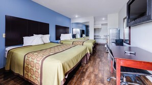 A hotel room with two beds, a desk, and a television. - Hotel O Luxury Inn Channelview Baytown I-10 (Channelview)