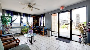 A hotel lobby with a reception desk, seating area, and large windows. - Hotel O Luxury Inn Channelview Baytown I-10 (Channelview)