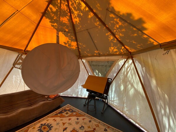 A tent interior with a large white circular object, a small table, and a patterned rug. - Bohemian Rhapsody Retreat ~ 2 Bed 3 Bath With Game and Theatre Room (Sedona)