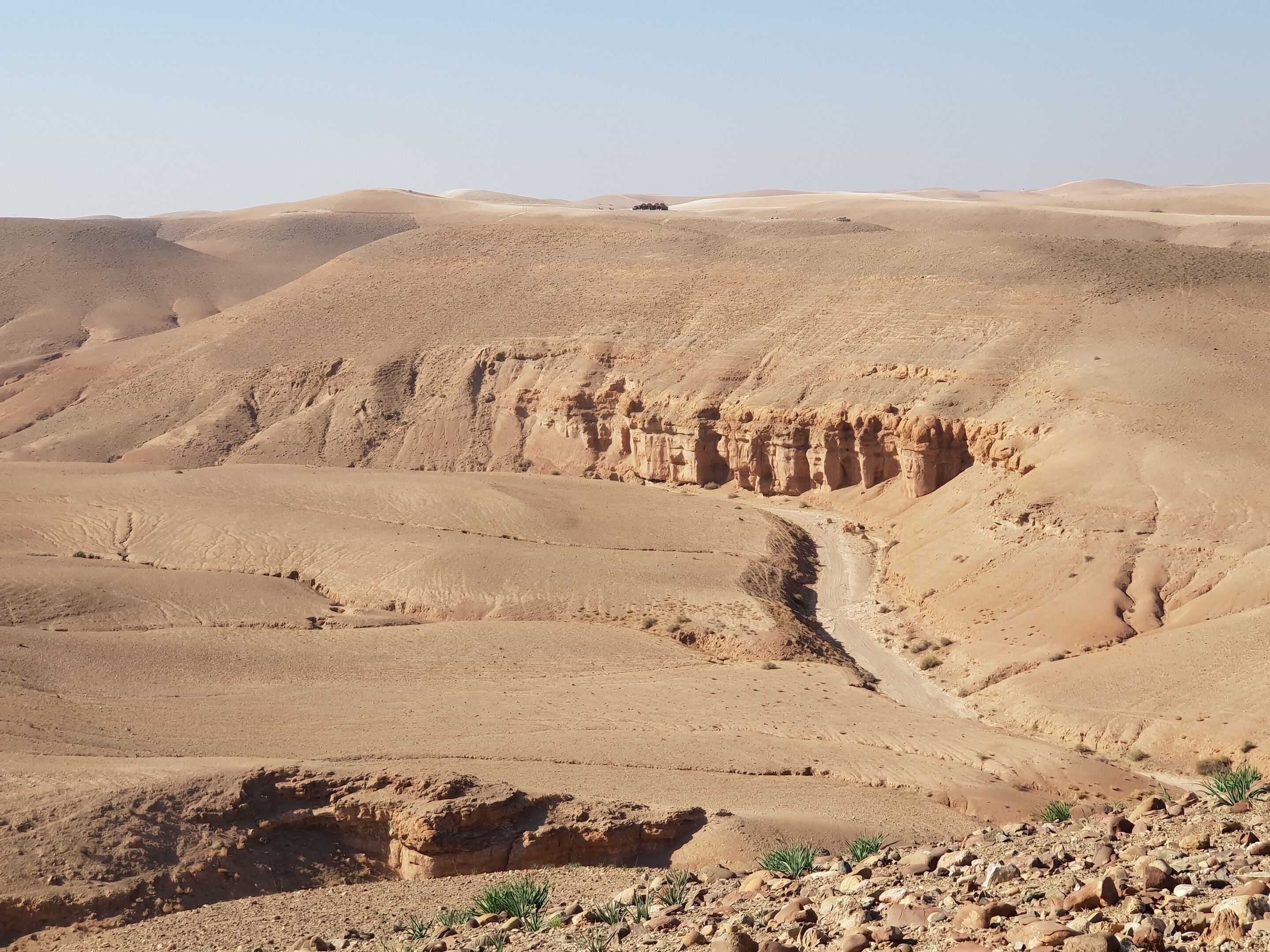 A desert landscape with a winding road and rocky terrain.