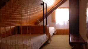 A room with two bunk beds, a wooden ceiling, a window with curtains, and a small bedside table with a lamp. - Paradise for hikers. Family friendly. (Crni Vrh nad Idrijo)