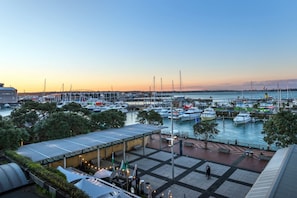 Enjoy waterfront relaxation and socializing at this marina, featuring covered areas and seating, modern architecture, and a spacious open plaza.
