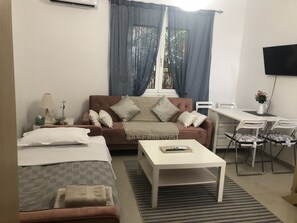 Relax in this inviting room with a single bed, sofa, and workspace.
