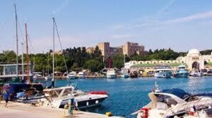 Enjoy waterfront views of the marina with boats docked and surrounding buildings.