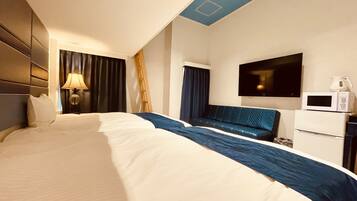 A hotel room with a large bed, a desk with a flat-screen TV, a microwave, and a coffee maker.