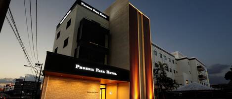 The Phoenix Park Hotel with a modern facade, a prominent entrance, and a well-lit exterior.