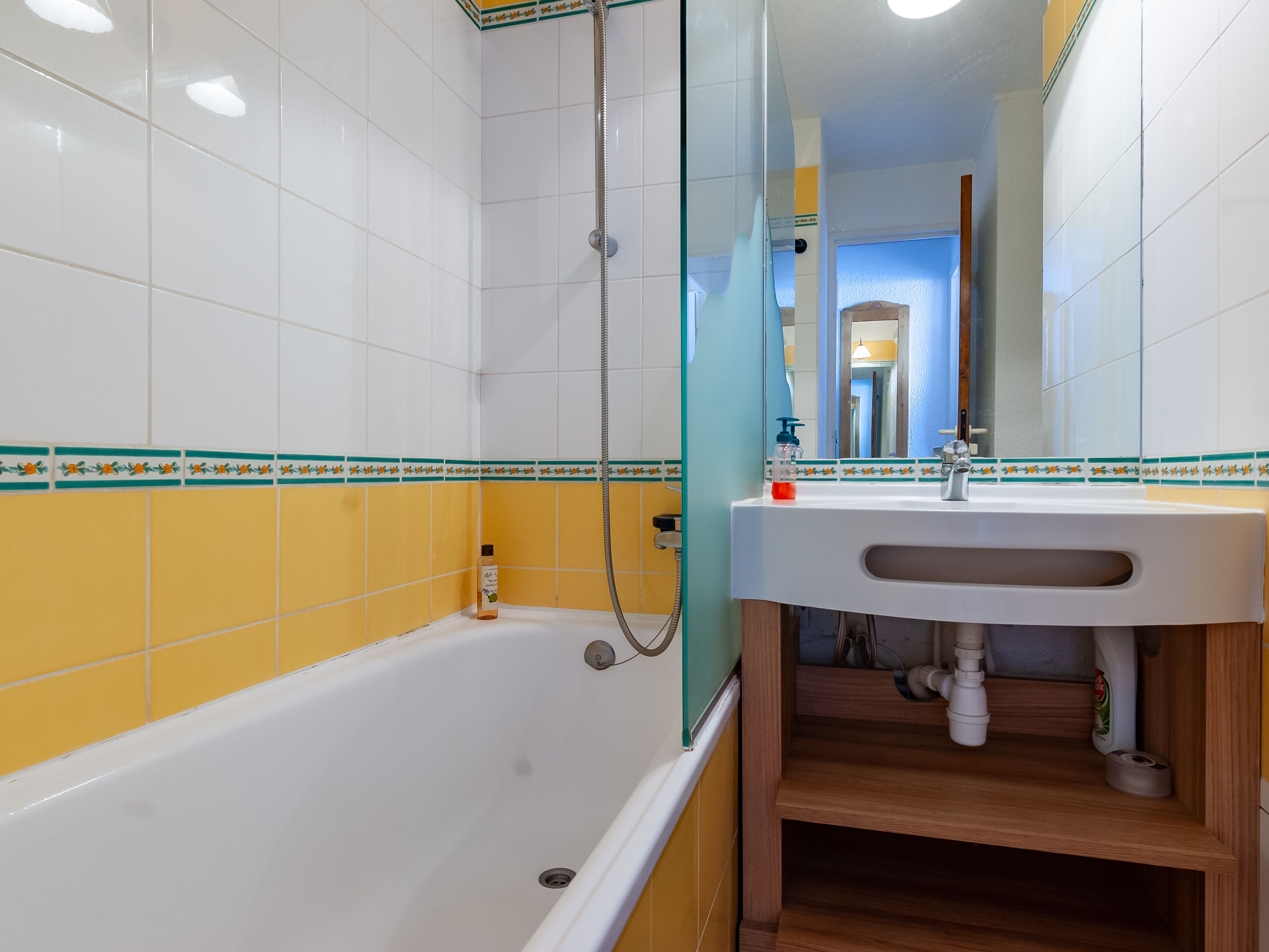 A bathroom with a bathtub, a sink, and a shower.