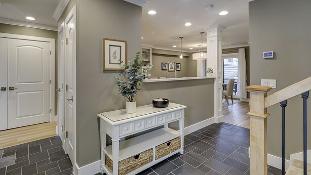 A hallway with a white console table, grey walls, and a staircase. - Sunset Rentals | Heritage Villas 2292 (Hilton Head Island)