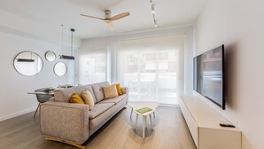 A modern living room with a sofa, a coffee table, a TV, and a ceiling fan. - Ref. 338306 (Motril)