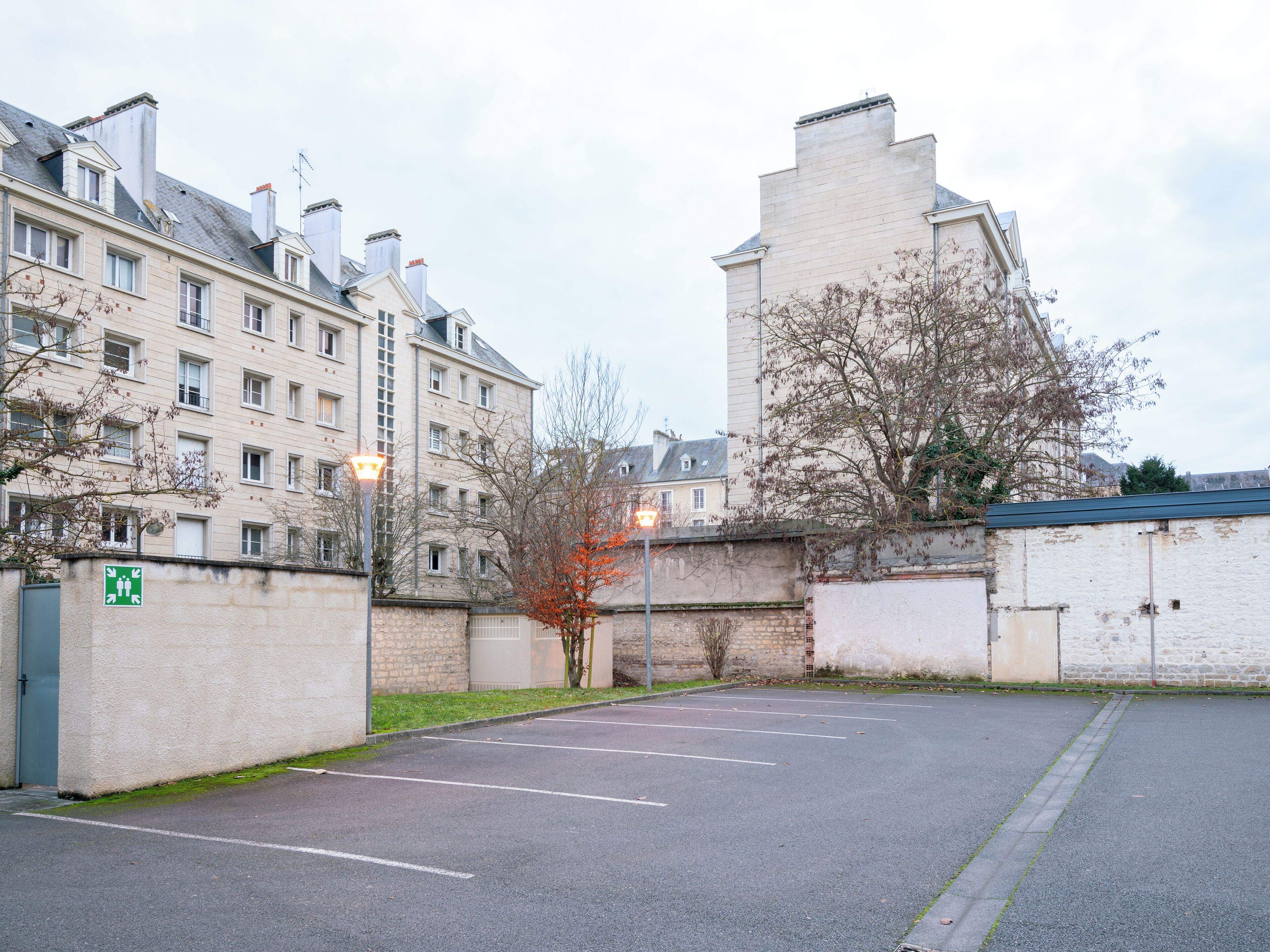 A parking lot with a building in the background.