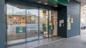 A B&B Home entrance with glass doors, a green awning, and a sign indicating availability. - B&B HOME Caen Centre Gare (Caen)