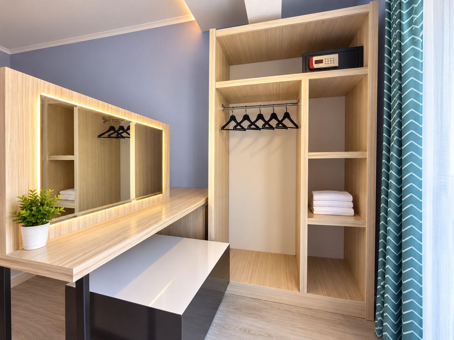 A modern bathroom with a vanity, mirror, and a shower area.