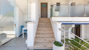 A modern staircase with glass railings leading to a wooden door marked "203". - 2132 Maresidence - Camere Triple (Salve)