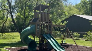 A playground with a slide and climbing structure. - Yellow Door Cottage - 3BR, Pet & family friendly! (Chattanooga)
