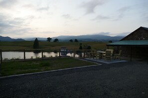 A rustic outdoor seating area with a view of a lake and distant mountains. - The Annexe at Loch View Farm will take your breath away (Crieff)